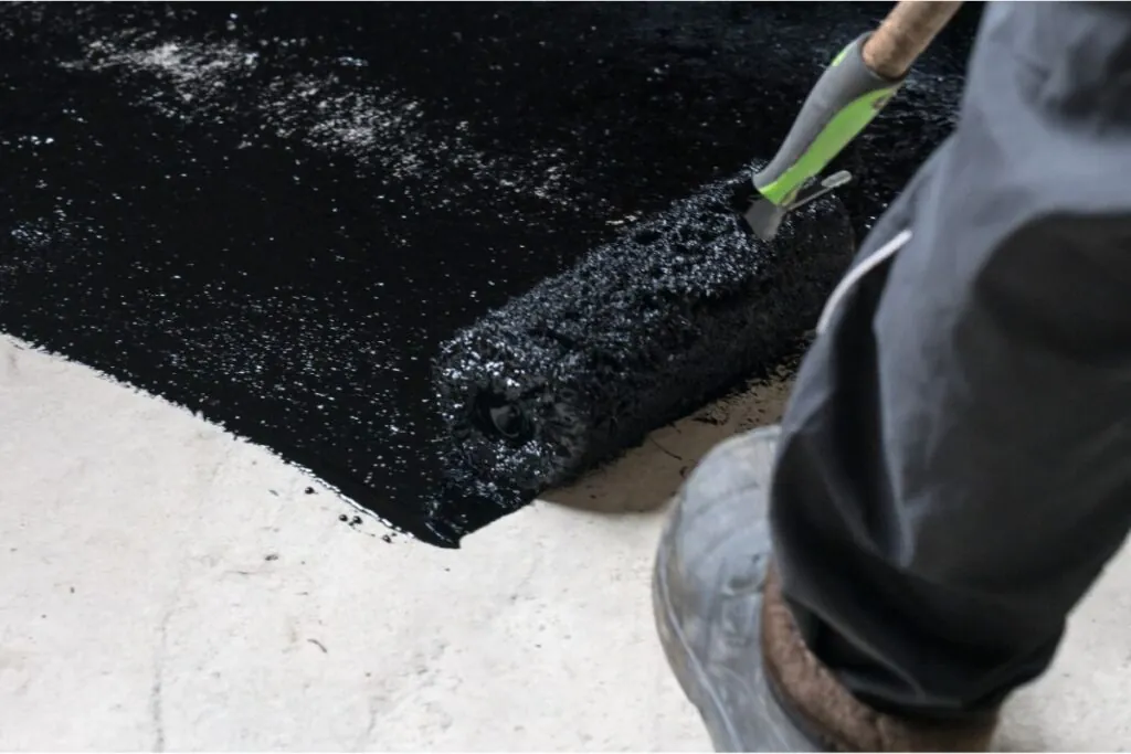 waterproofing the floor in a private house applying liquid resin to the floor concrete