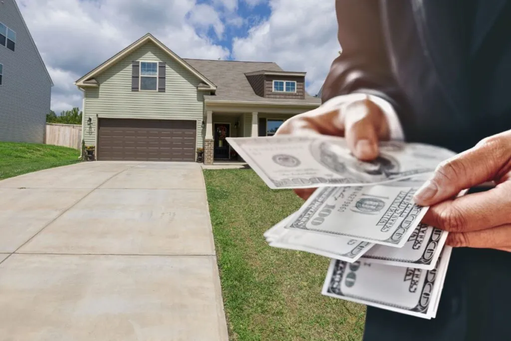 home owner holding dollar on his hands